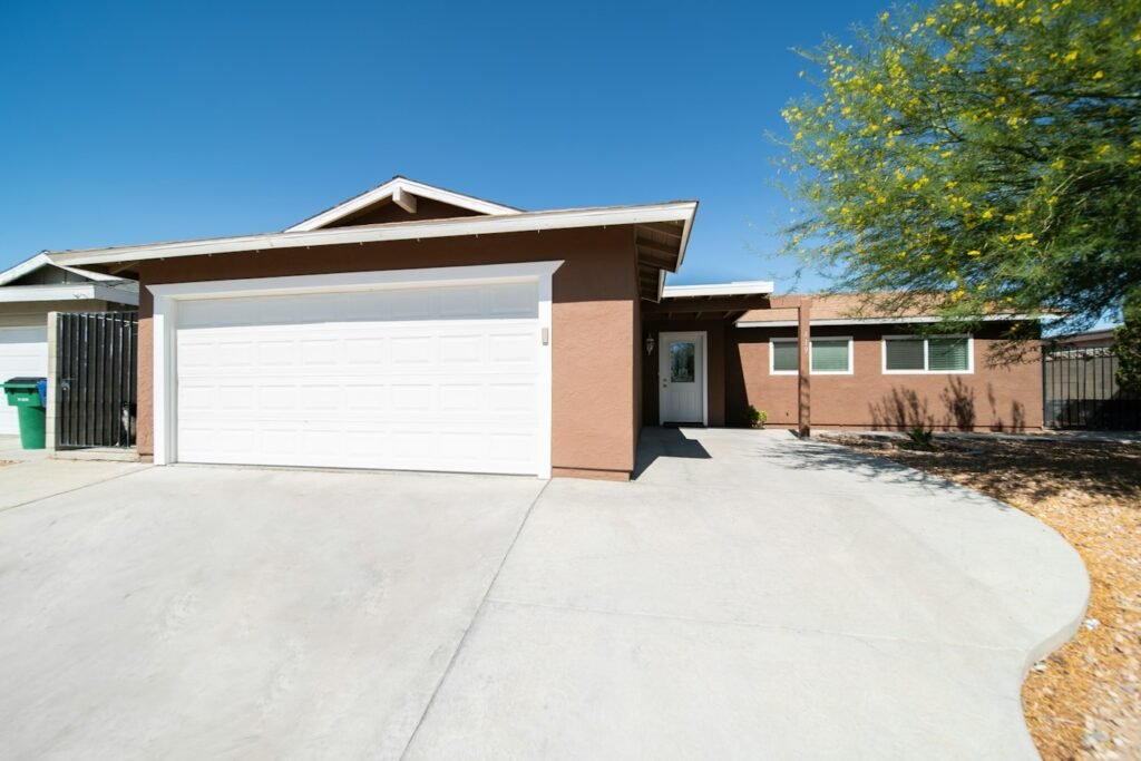 Ranch-style home with a clean concrete driveway